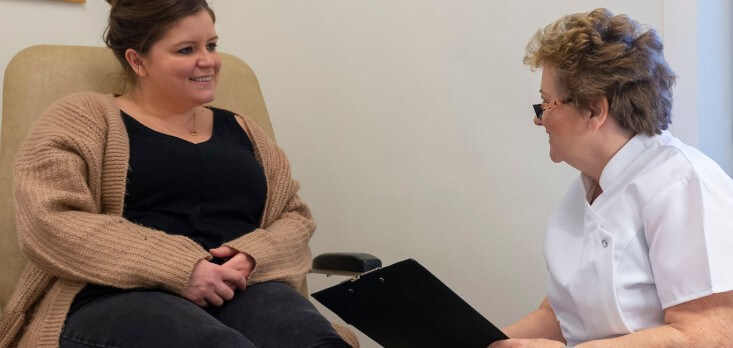A patient talking to Gill Renouf at Footprints Podiatry Clinic, Hull