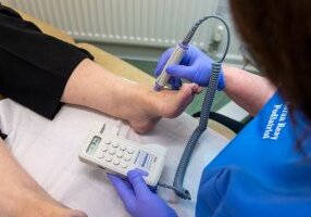 Podiatrist Karan Ray treating a patient using a doppler device at Footprints Clinic, Hull