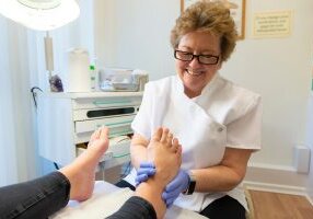 Podiatrist Gill Renouf treating a patient's feet