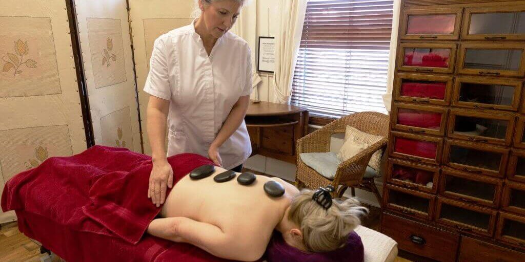 A patient enjoying a hot stone massage at Footprints Clinic, Hull